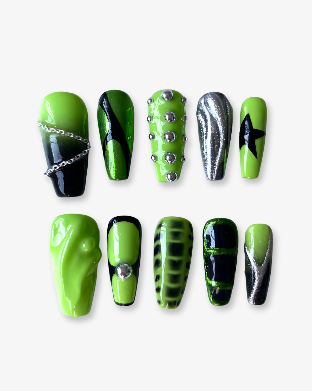 A full set of neon green press-on nails with edgy Y2K designs, including chrome accents, silver studs, black flames, and a bold star detail—perfect for a statement nail look.